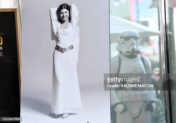 Poster of Star Wars character Princess Leia and the refection of a Trooper are seen at the ceremony for Carrie Fisher being honored posthumously with...