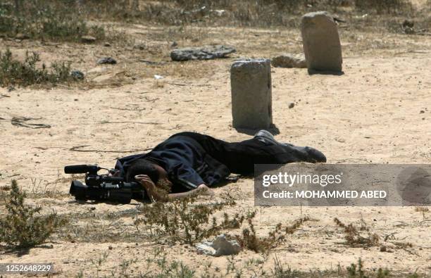 An al-Aqsa TV cameraman Imad Ganem is seen wounded on the ground during an Israeli military incursion into into the al-Burij refugee camp in the...