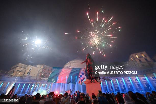 Fans of SSC Napoli celebrate with fireworks on Piazza del Plebiscito on May 4, 2023 in downtown Naples after Napoli won the Italian champions...