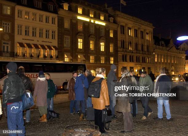 Employees of the Danish newspaper Jyllands-Posten stand in front of the paper's building in Copenhagen 31 January 2006. The offices of Danish...