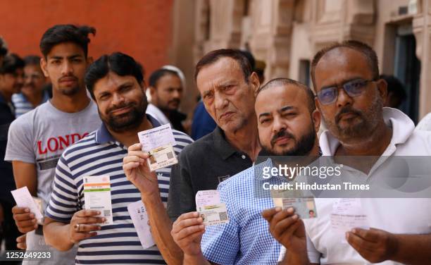 Muslim voters standing in a queue to cast their votes during the local bodies election at the picture gallery polling booth of Hussinabad area on May...