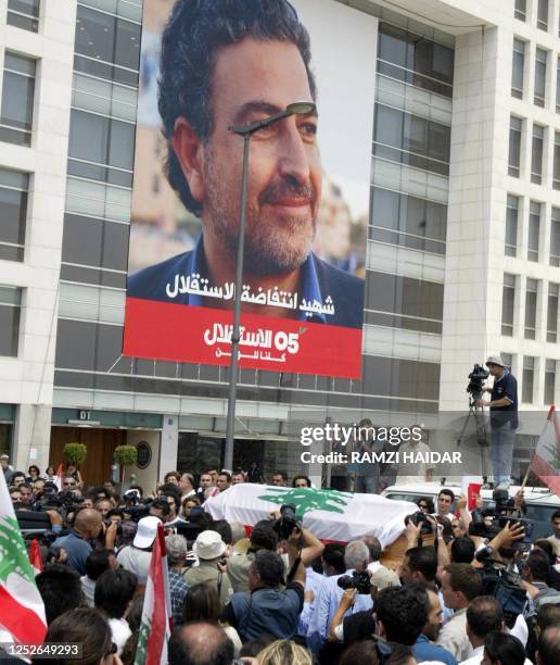 Lebanese mourner carry the coffin of murdered columnist Samir Kassir who regularly wrote virulent articles against Syria's domination of Lebanon,...