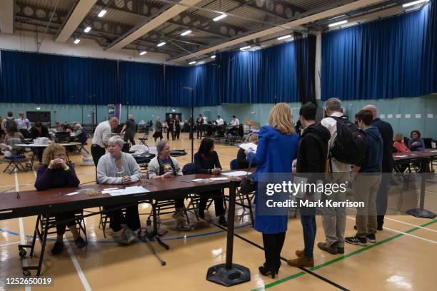 Candidates and other invited guests observe preparations for the counting of votes at the local election count for the Royal Borough of Windsor and...