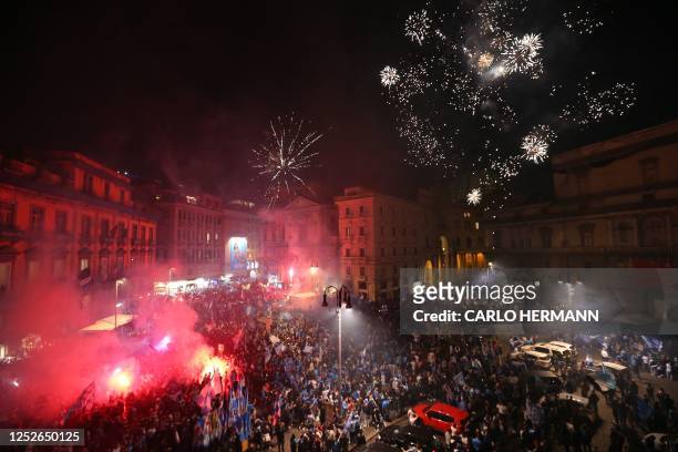 Fans of SSC Napoli celebrate with fireworks on May 4, 2023 in Naples after Napoli won the Italian champions "Scudetto" title following a decisive...