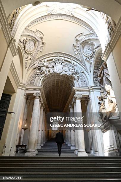 This photo taken on April 26, 2023 shows a Swiss Guard in civilian clothing walking across a flight of stairs in the Apostolic Palace, in the days...