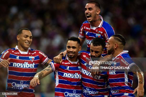Fortaleza's midfielder Yago Pikachu celebrates with teammates after scoring during the Copa Sudamericana group stage first leg football match between...