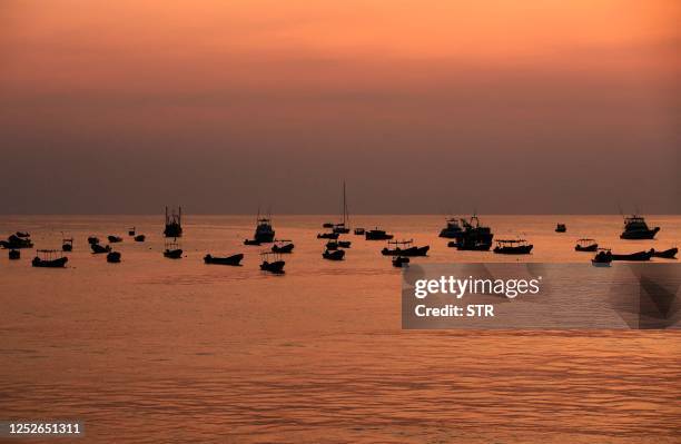 General view of boats the bay of the Pacific coastal town of San Juan del Sur, Nicaragua, during sunset on April 25, 2023. - Drawn to the natural...