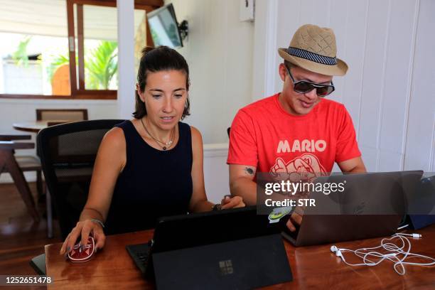 Christina Alty and Henry Ferrery work in their Invest Nicaragua office in the Pacific coastal town of San Juan del Sur, Nicaragua, on April 25, 2023....