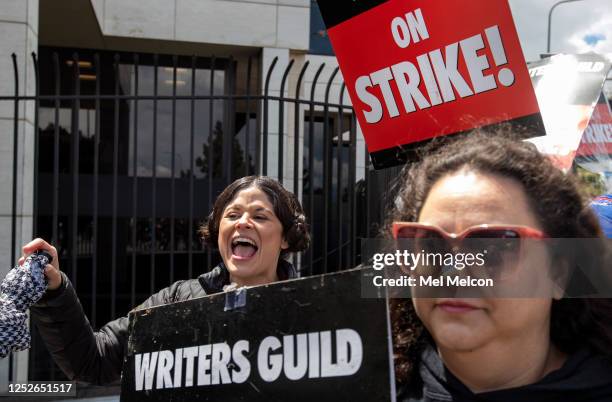 Judalina Neira, left, a lot coordinator for writers striking outside of NBC/Universal Studios in Universal City, dresses up as Princess Leia from the...