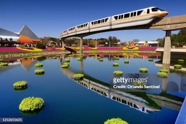 Monorail train passes over floating gardens at the 2022 Epcot International Flower &amp; Garden Festival at Walt Disney World.