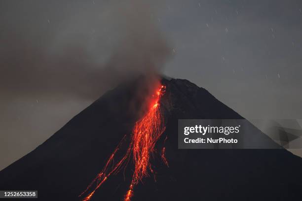 Mount Merapi, a volcanic mountain spews lava as it erupts several times during sunrise from Kaliurang village, Srumbung district in Magelang, Central...