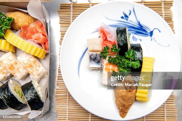 Siblings Emi Tani Castillo, Jason Tani and Jeff Tani, prepare and showcase an assortment of sushi offered at Sakae Sushi onto their grandmothers...