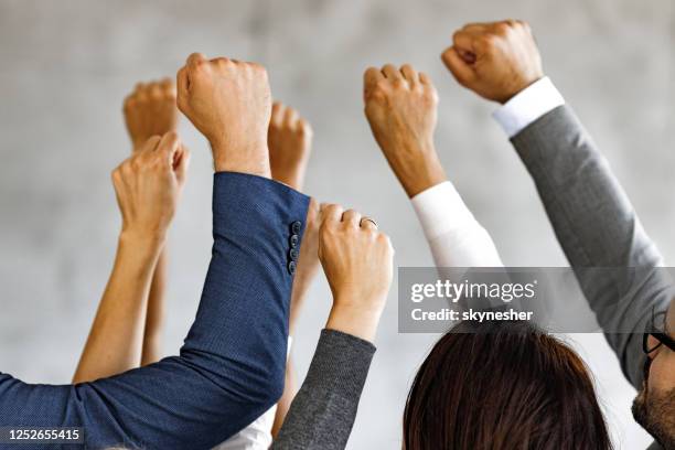 raise your hands in protest! - punching the air stock pictures, royalty-free photos & images