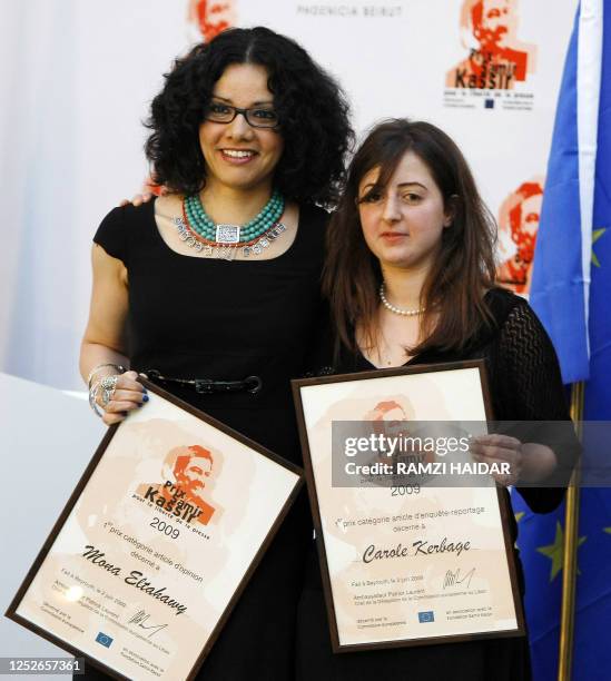 Egyptian journalist Mona el-Tahawy and Lebanese Carole Kerbage pose with their Samir Kassir awards during a ceremony at a hotel in downtown Beirut on...