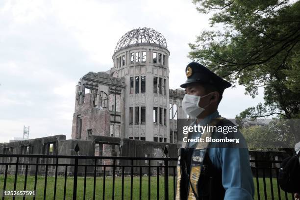 Police officer stands guard in front of the Atomic Bomb Dome at the Hiroshima Peace Memorial Park ahead of the Group of Seven Summit in Hiroshima,...
