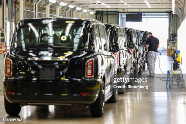 An employee checks the bodywork quality of a TX electric London black cab at the London EV Co. Manufacturing plant in Coventry, UK, on Thursday, May...