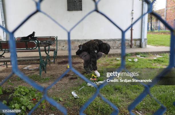 Crime scene investigator looks for evidence onsite inside the school in the village Dubona, near Mladenovac on May 5, 2023 in Dubona, Serbia. A...