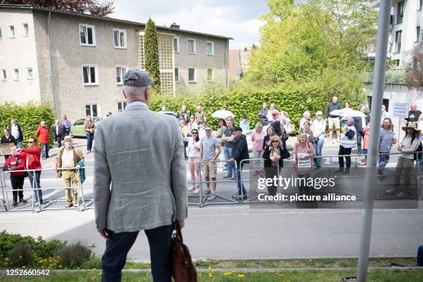 May 2023, Hesse, Königstein im Taunus: Albrecht Glaser, former state spokesman of the AfD Hesse, walks past demonstrators during a protest rally for...