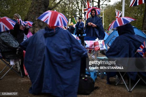 Royal fans are seen camping out along the procession route with the their tents and camping chairs on The Mall, near to Buckingham Palace in central...