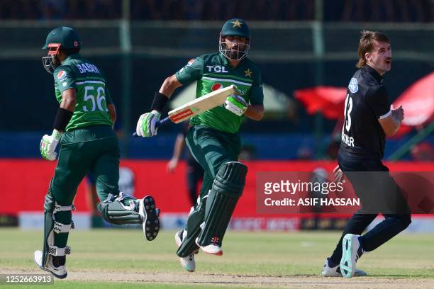 Pakistan's Babar Azam and Shan Masood run between the wickets during the fourth one-day international cricket match between Pakistan and New Zealand...