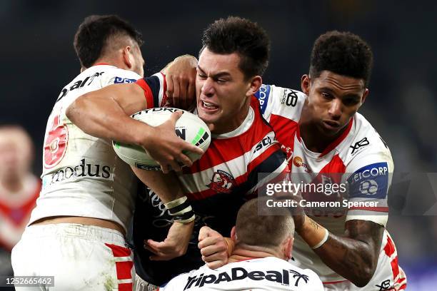 Joseph Manu of the Roosters is tackled by Corey Norman, Jason Saab and Matthew Dufty of the Dragons during the round seven NRL match between the...