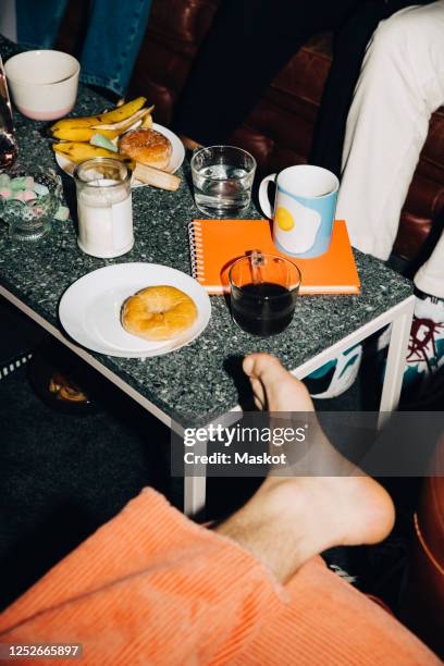 high angle view of food on table in creative office - coffee table books stockfoto's en -beelden