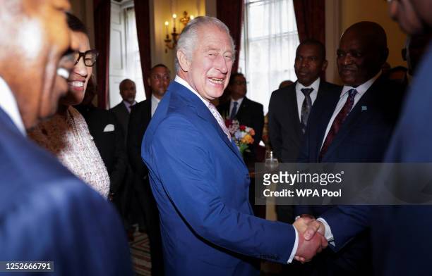 King Charles III is greeted at an informal meeting with Commonwealth Leaders at Marlborough House on May 5, 2023 London, England.