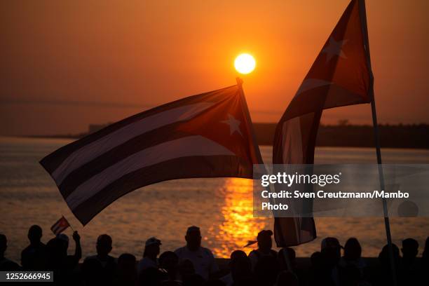 Cuban flags are being waved as the sun rises during the May Day celebrations, on May 5, 2023 in Havana, Cuba. Cuba had canceled its annual May Day...