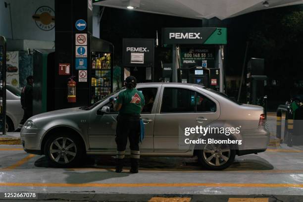 Workers charges a customer at a Petroleos Mexicanos gas station in Mexico City, Mexico, on Thursday, May 4, 2023. The Mexican government is not...