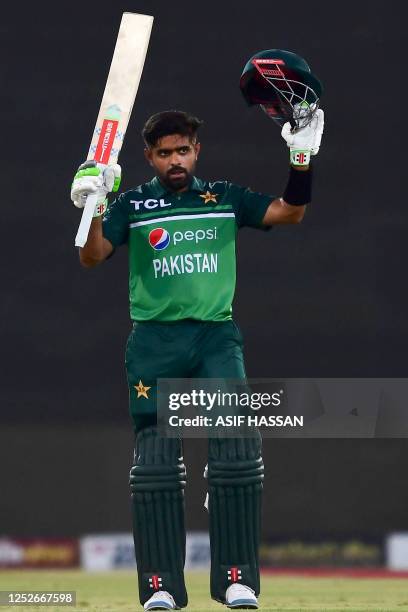 Pakistan's captain Babar Azam celebrates after scoring a century during the fourth one-day international cricket match between Pakistan and New...