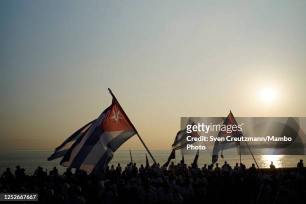 Cuban flags are being waved as the sun rises during the May Day celebrations, on May 5, 2023 in Havana, Cuba. Cuba had canceled its annual May Day...
