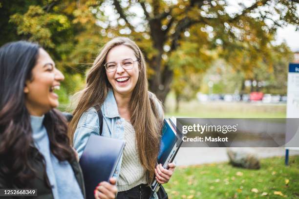 happy young female friends in university campus - campus life stock pictures, royalty-free photos & images