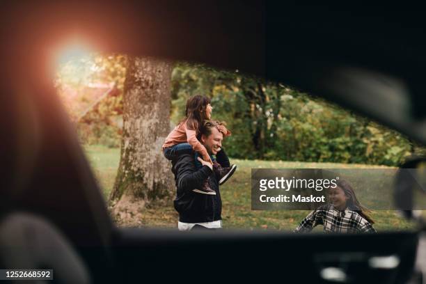 father playing with daughters during picnic in weekend - father sun stock pictures, royalty-free photos & images