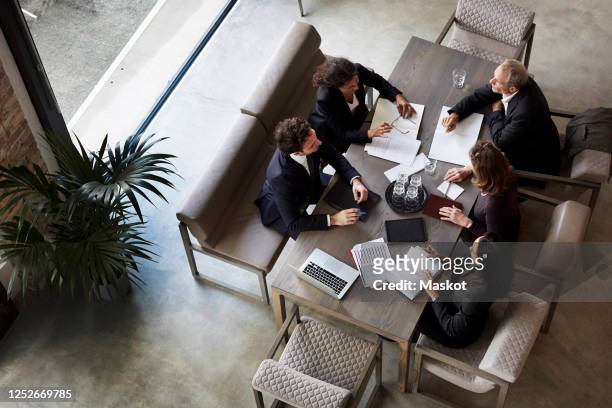 team of lawyers planning with business colleagues during meeting at law firm - business suits discussion stock-fotos und bilder