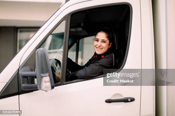 confident young delivery woman driving truck - arab woman driving stock pictures, royalty-free photos & images