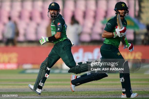 Pakistan's captain Babar Azam and Agha Salman run between the wickets during the fourth one-day international cricket match between Pakistan and New...