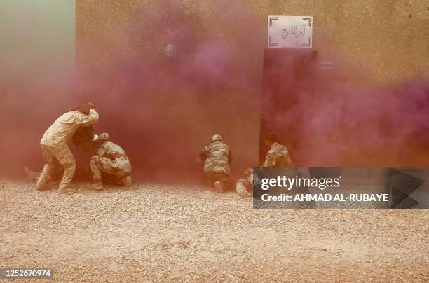 Iraqi military rescue officers are put through their paces during a training session on emergency rescue at the old Muthana airport in Baghdad on May...