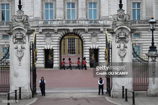 Guards patrol inside Buckingham Palace in central London, on May 5 ahead of the coronation weekend. - The country prepares for the coronation of...