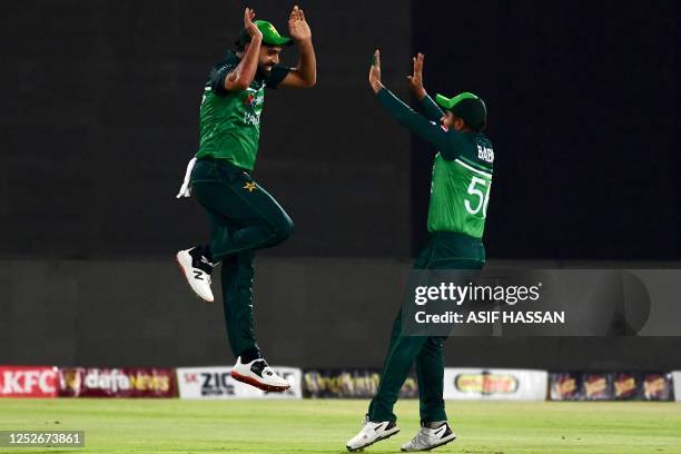 Pakistan's captain Babar Azam and Haris Rauf celebrate after the dismissal of New Zealand's Will Young during the fourth one-day international...