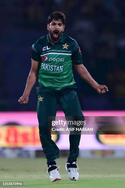 Pakistan's Haris Rauf celebrates after taking the wicket of New Zealand's Tom Blundell during the fourth one-day international cricket match between...