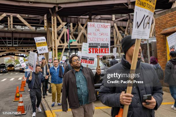 Writers Guild of America members march on a picket line in front of Silvercup Studios. After contract negotiations failed, thousands of unionized...