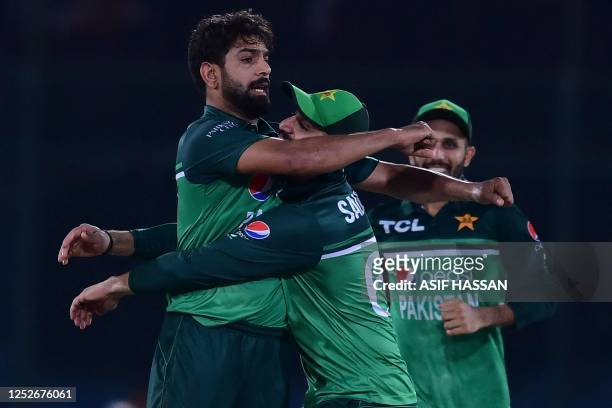Pakistan's Haris Rauf celebrates with teammates after taking the wicket of New Zealand's James Neesham during the fourth one-day international...