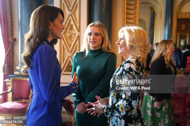 Catherine, Princess of Wales speaks with the First Lady of the United States, Dr Jill Biden and her grand daughter Finnegan Biden during a reception...