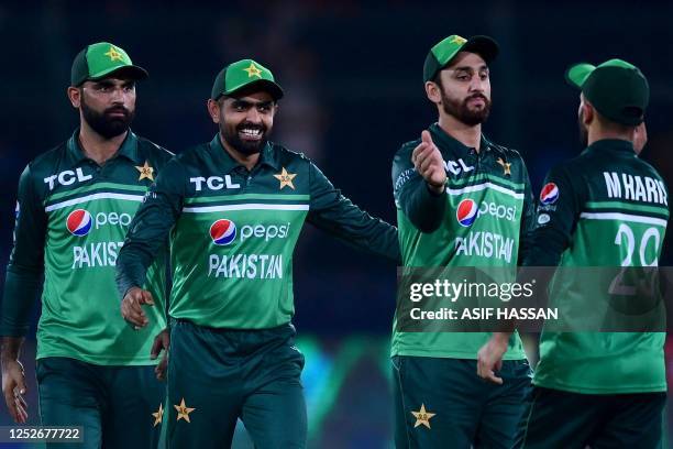 Pakistan's captain Babar Azam and his teammates celebrate after winning the fourth one-day international cricket match between Pakistan and New...