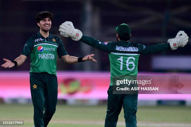 Pakistan's Mohammad Wasim and teammate Mohammad Rizwan celebrate after winning the fourth one-day international cricket match between Pakistan and...