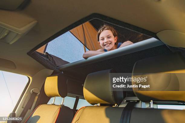 Happy young girl in her camper van