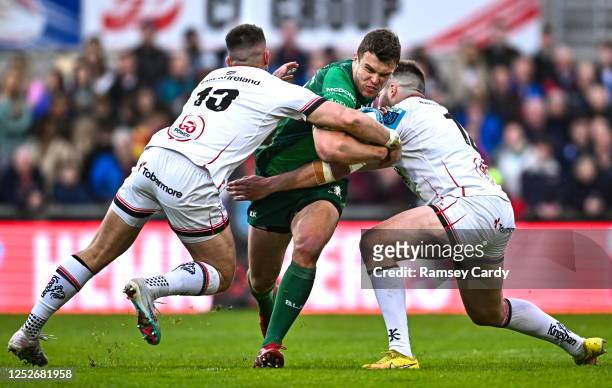 Belfast , United Kingdom - 5 May 2023; Tom Farrell of Connacht is tackled by James Hume, left, and Stuart McCloskey of Ulster during the United Rugby...