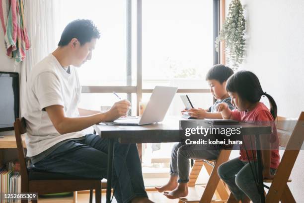 father working at home with children - freelance child stock pictures, royalty-free photos & images