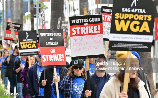 Writers on strike march with signs on the picket line on day four of the strike by the Writers Guild of America in front of Netflix in Hollywood,...
