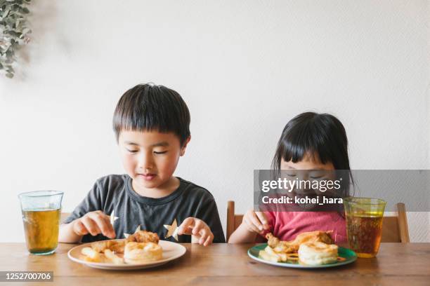 children having lunch at home - asian young boy smiling stock pictures, royalty-free photos & images